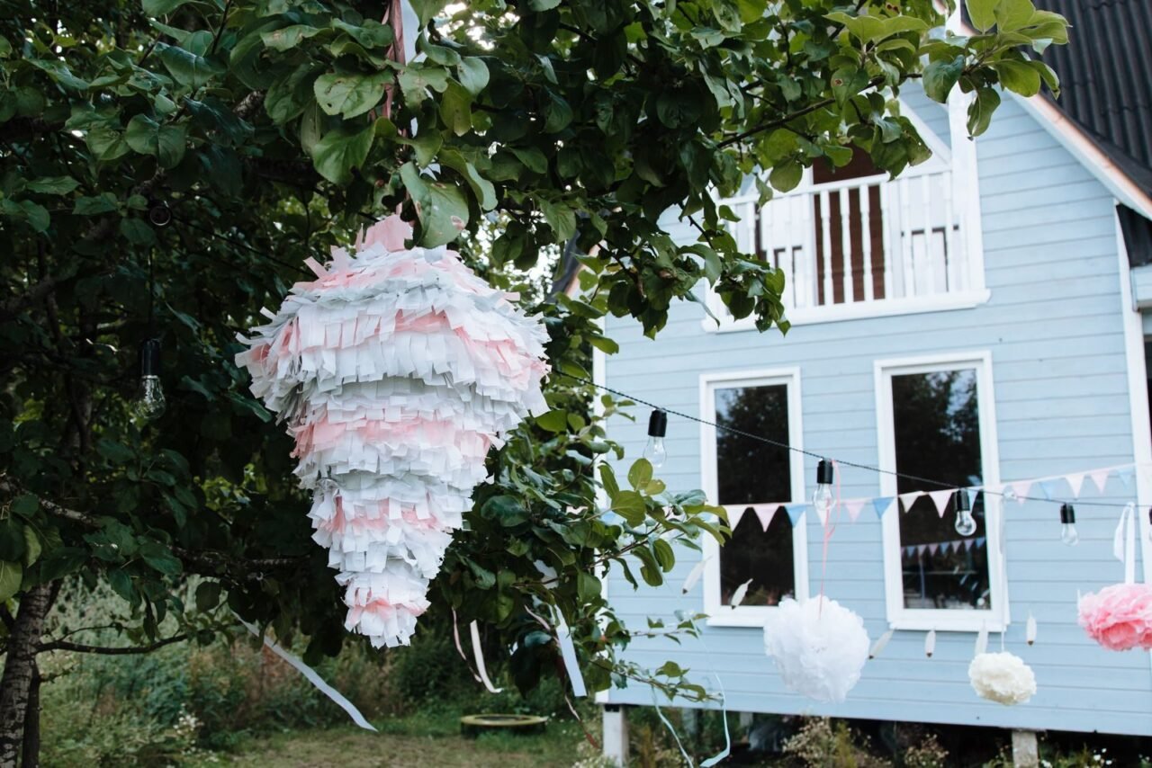 A festive piñata and decorations in a vibrant garden setting, perfect for outdoor celebrations.