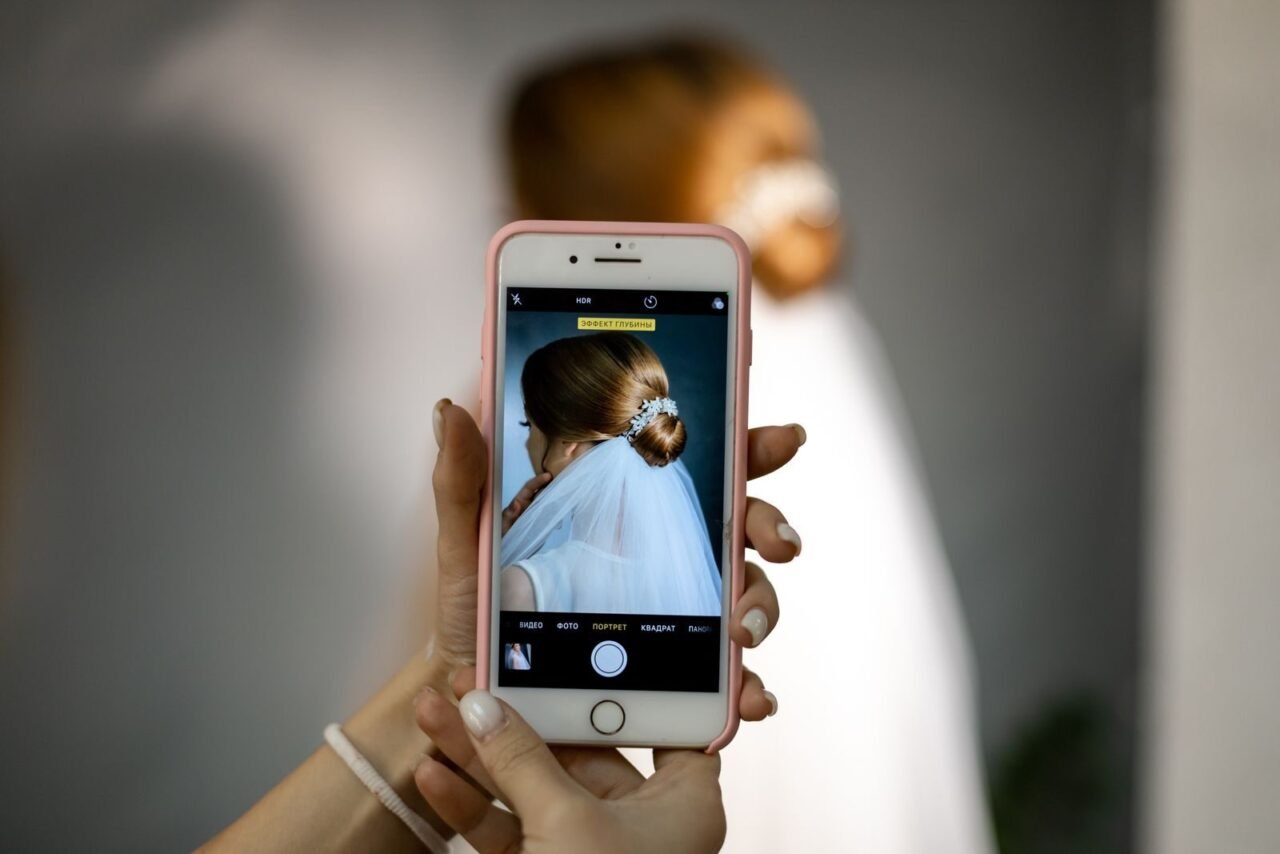 A bridal portrait taken with a smartphone, focusing on the bride's hairstyle.