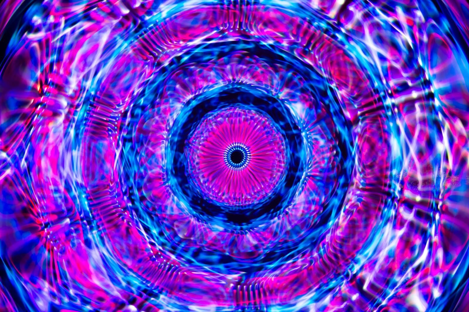 Dynamic psychedelic kaleidoscope pattern with vivid colors and intricate design.