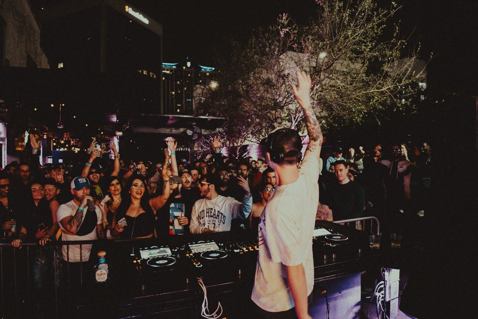 Vibrant DJ performance at an outdoor nightlife event in Orlando with a lively crowd.