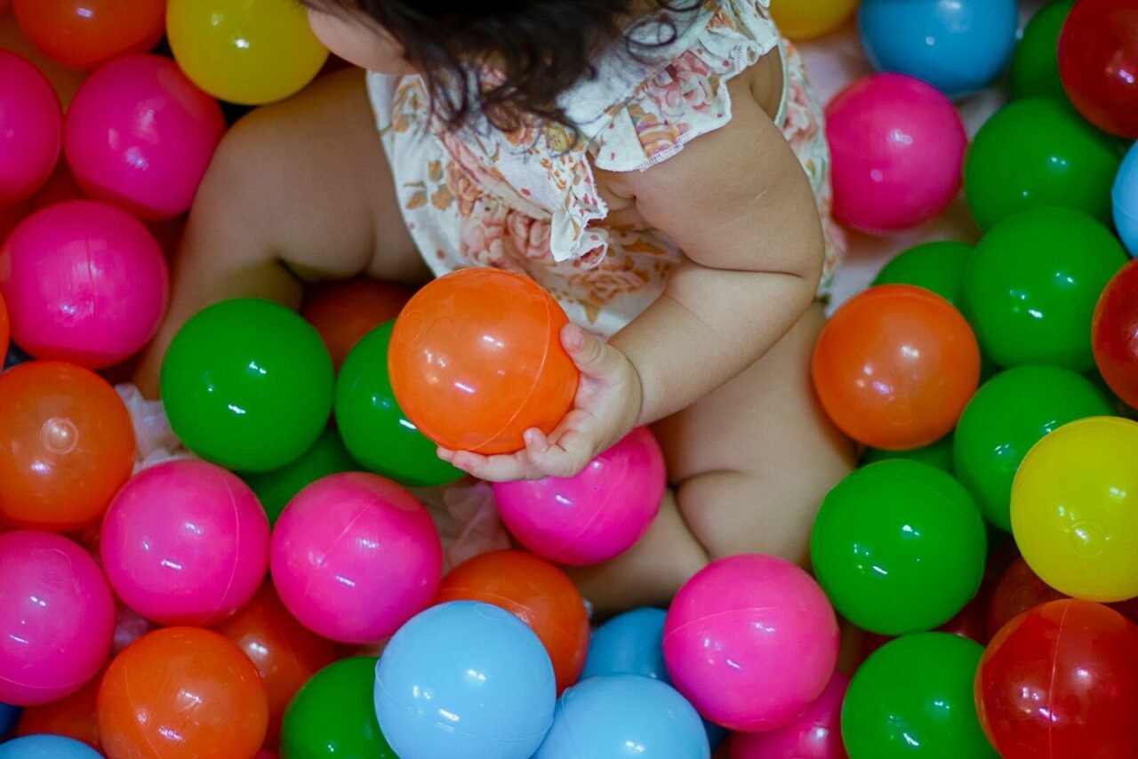 a baby is sitting in a ball pit