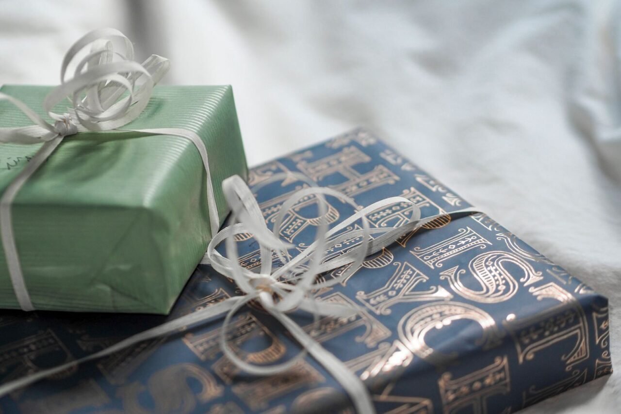 Close-up of elegant gift boxes wrapped in luxurious paper with delicate ribbons.