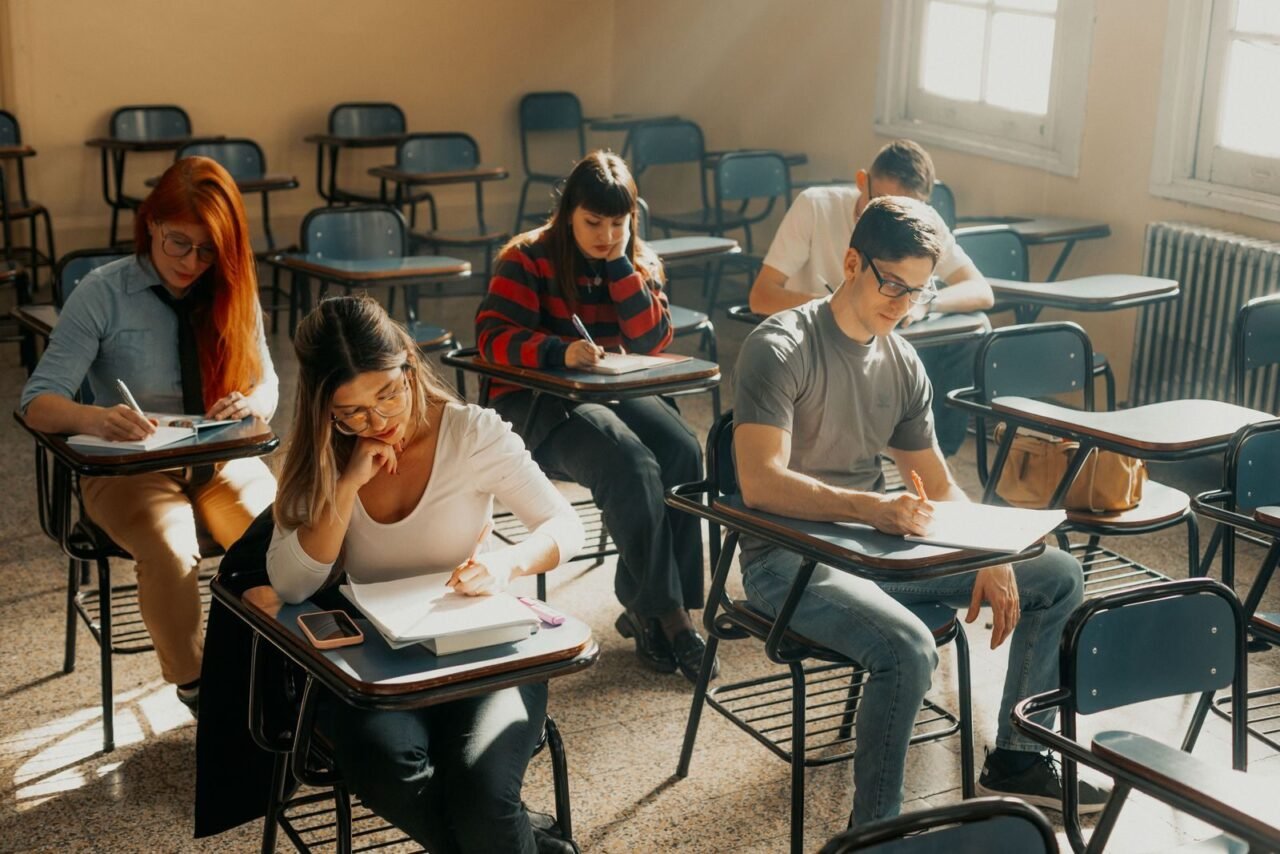Students studying seriously in a Buenos Aires classroom setting during the day.