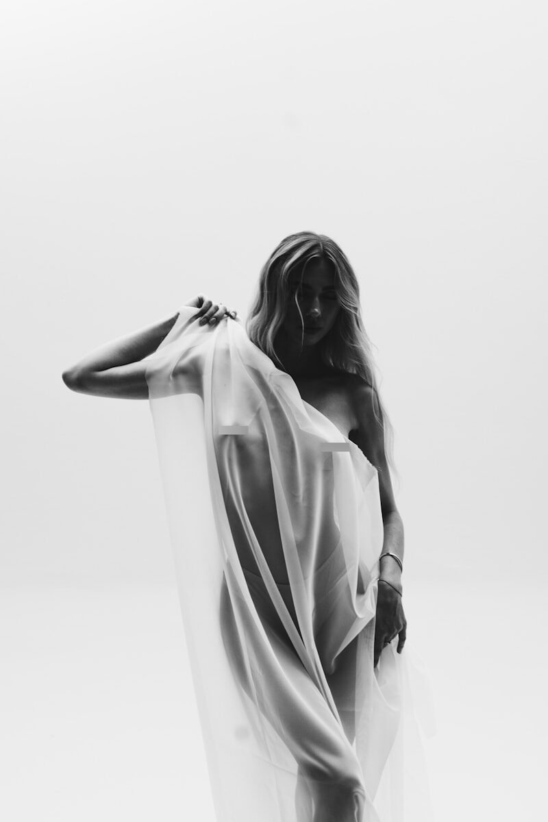 A black and white photo of a woman in a flowing dress