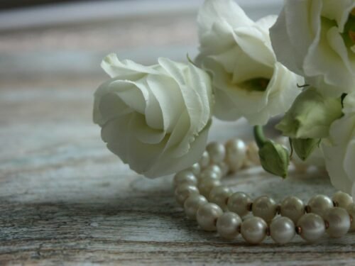 white rose on brown wooden table