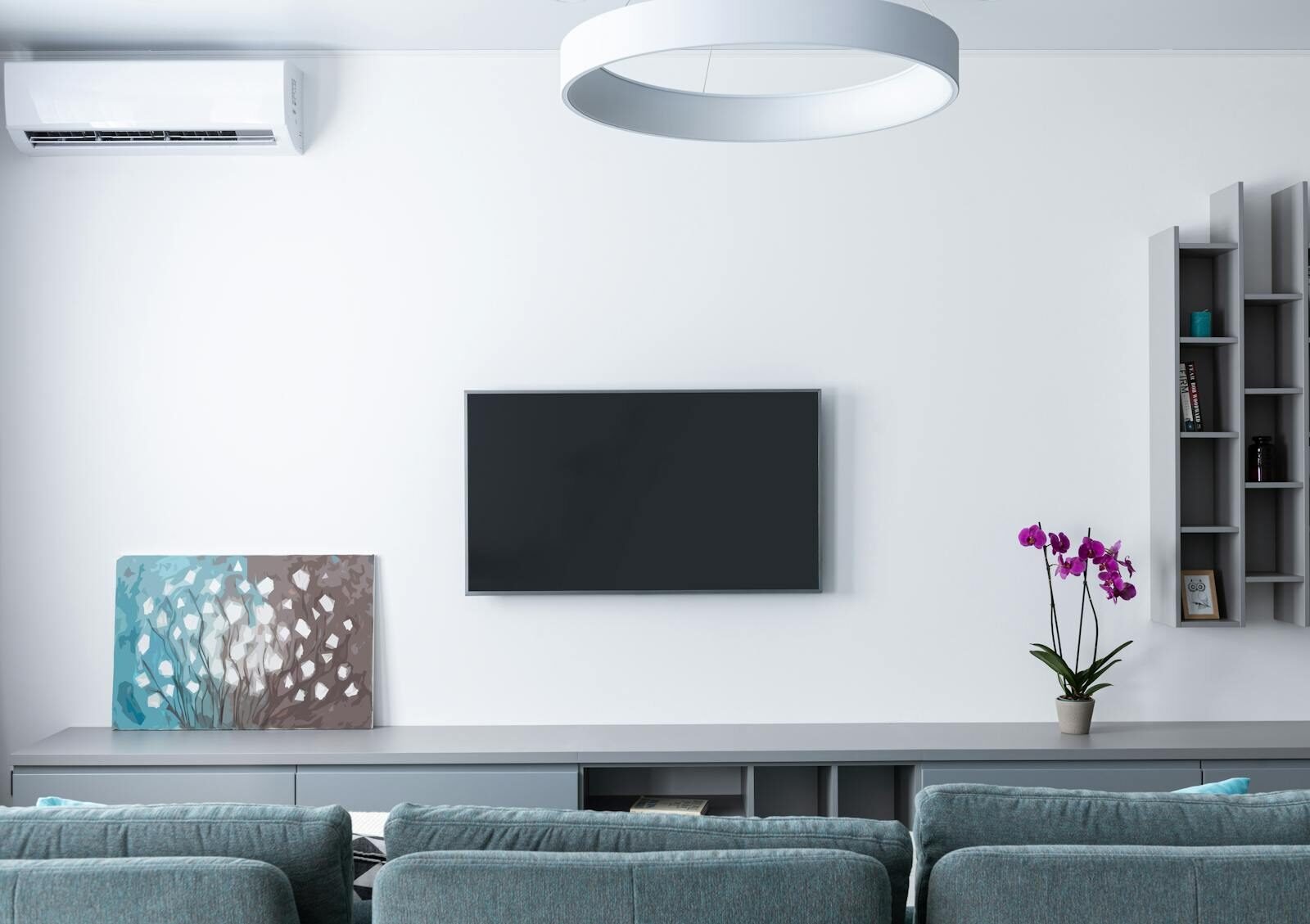 Contemporary living room decorated with purple flowers and rectangular shaped shelves handing on wall