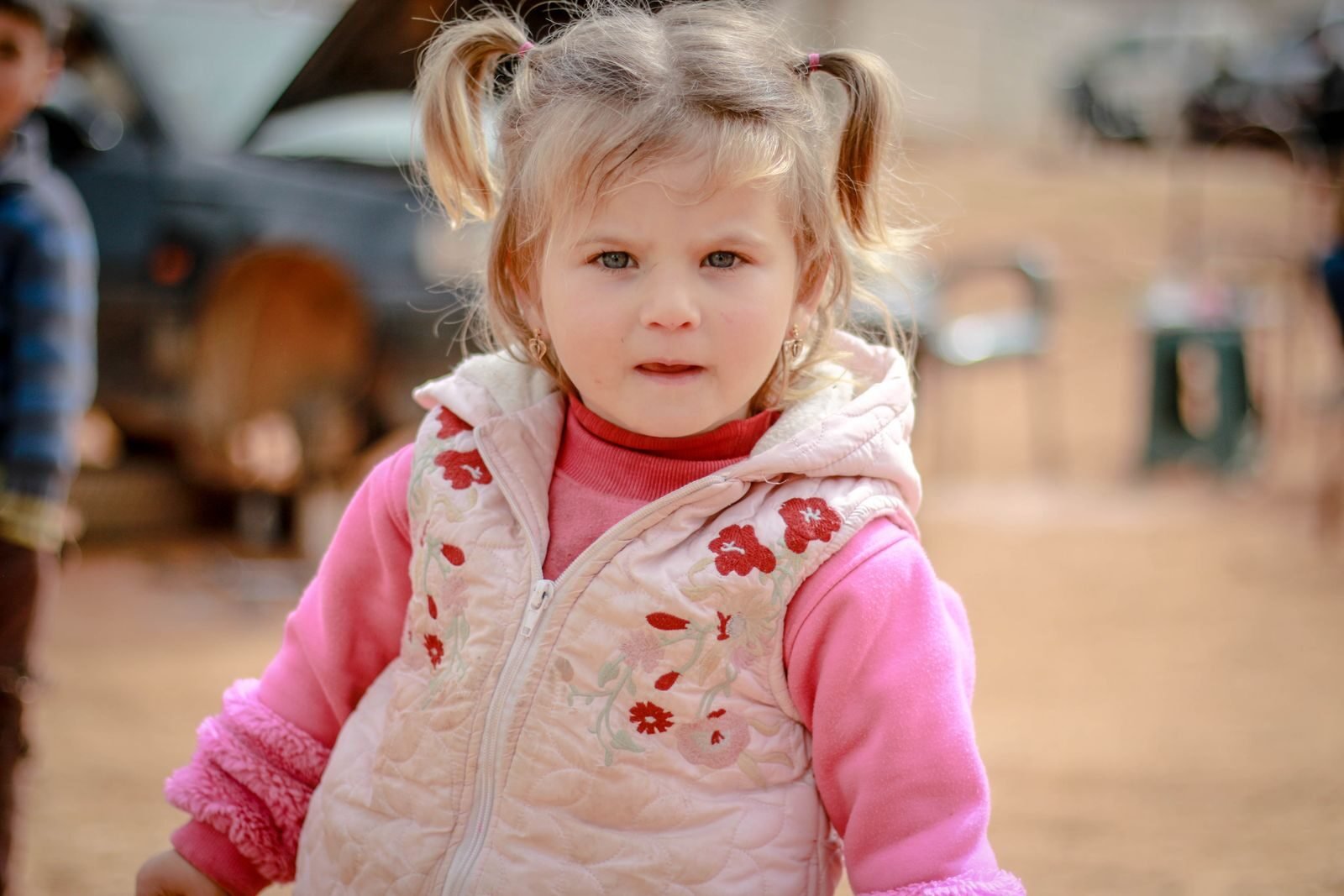 Portrait of a young girl wearing pink clothes outdoors in Idlib, Syria.