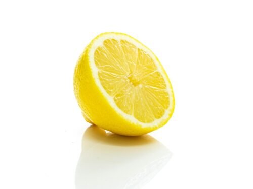 yellow lemon fruit on white surface