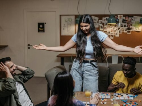 Group of diverse friends playing board games indoors, having fun together.