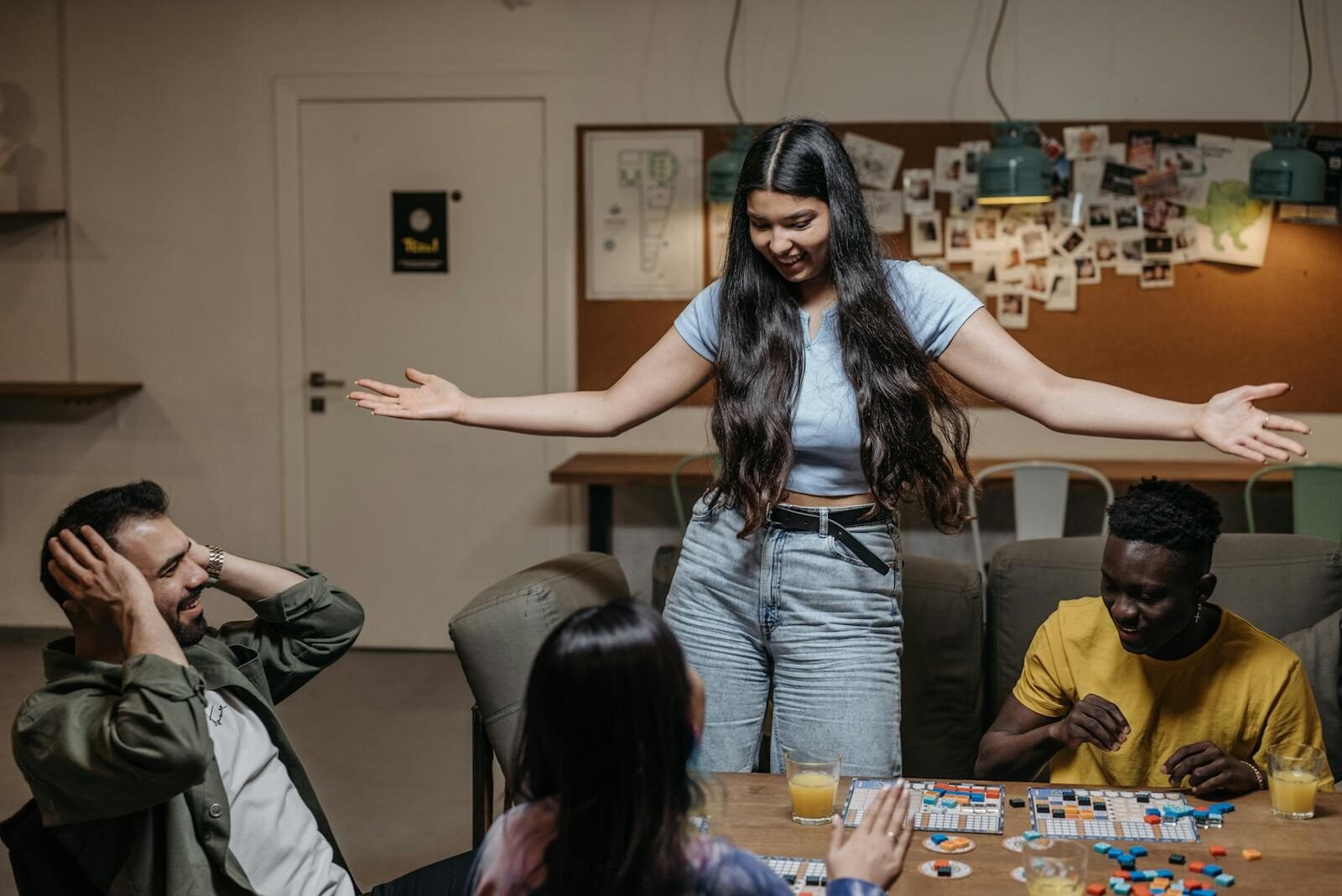 Group of diverse friends playing board games indoors, having fun together.