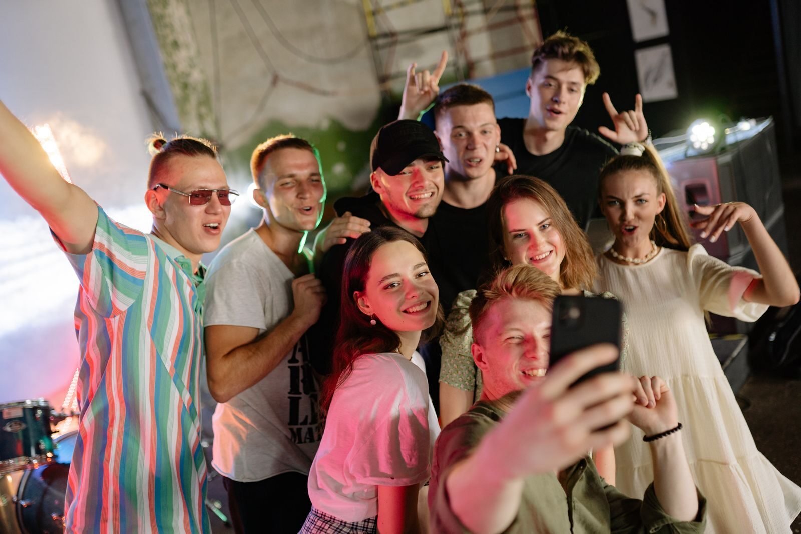A lively group of friends capturing a fun moment with a selfie during a party.