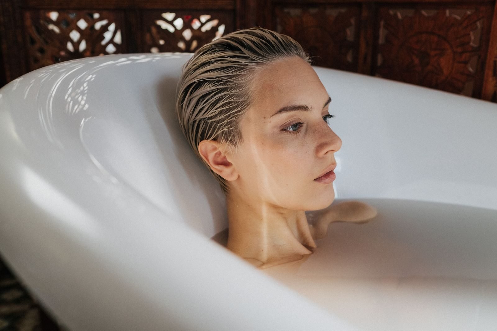 A serene moment of relaxation featuring a woman in a bathtub, highlighting self-care and tranquility.