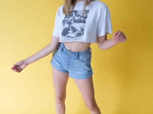 woman in white shirt and blue denim shorts