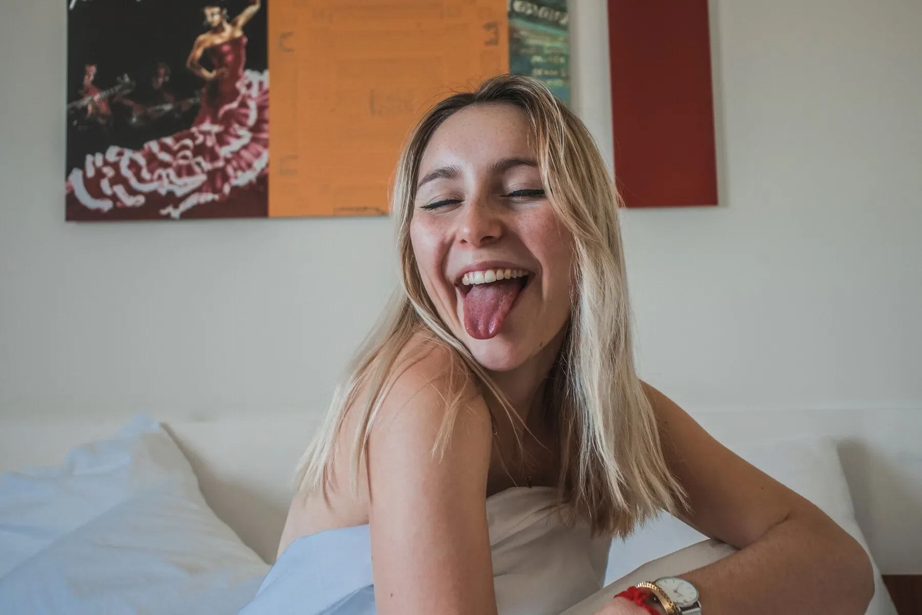 Blonde woman sticking tongue out