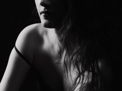 a black and white photo of a woman with long hair