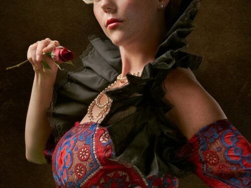 woman wearing red, blue, and white floral jaboot-neckline dress