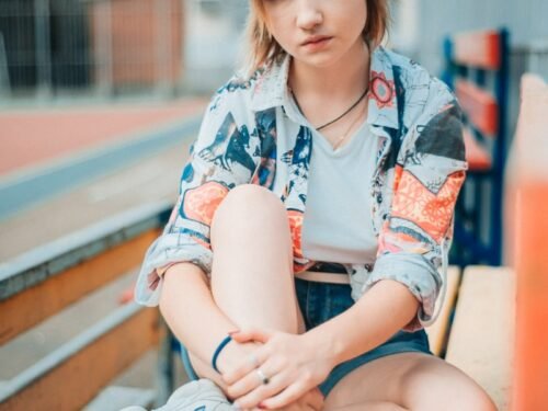 woman sitting on wooden bench