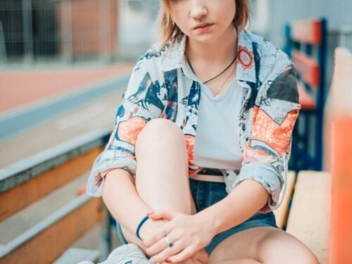 woman sitting on wooden bench