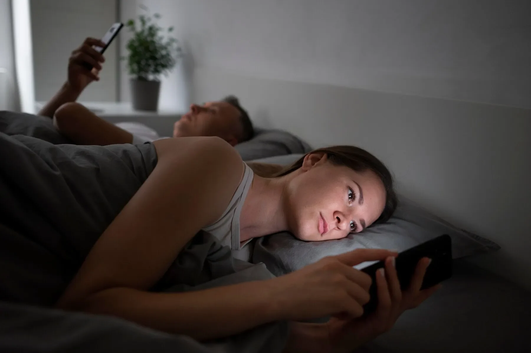 Close up couple phones bedroom