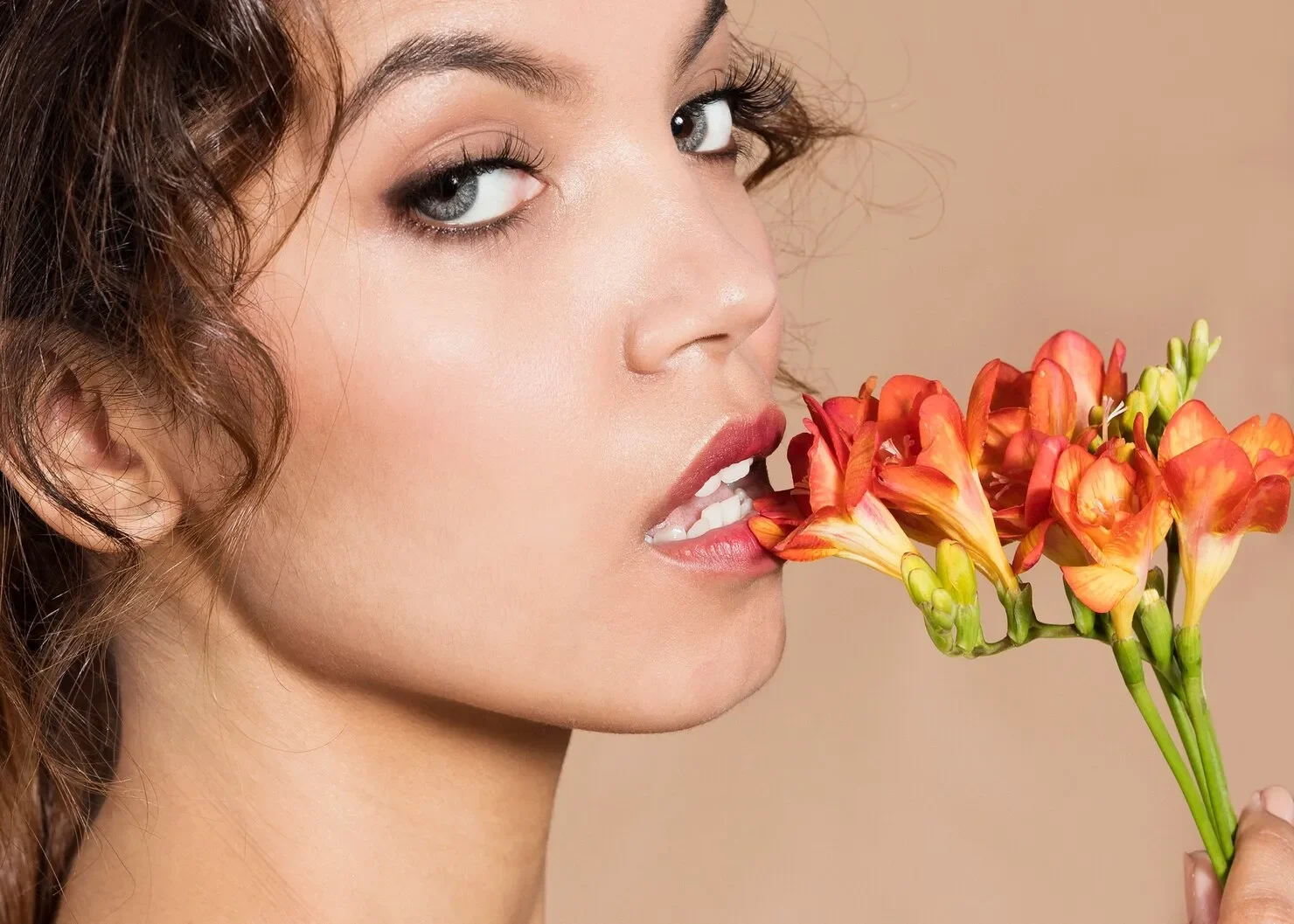 Close up shot young woman holding flowers