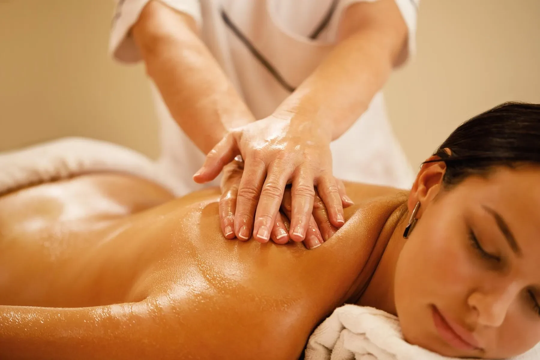 Closeup woman relaxing back massage spa salon