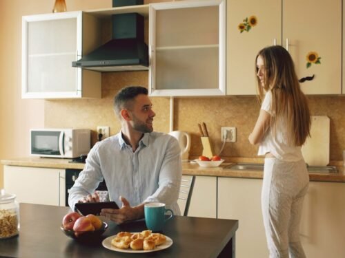 Couple talking in a modern kitchen during breakfast