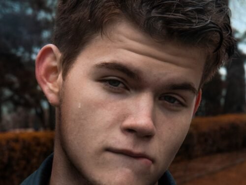 man in black collared shirt