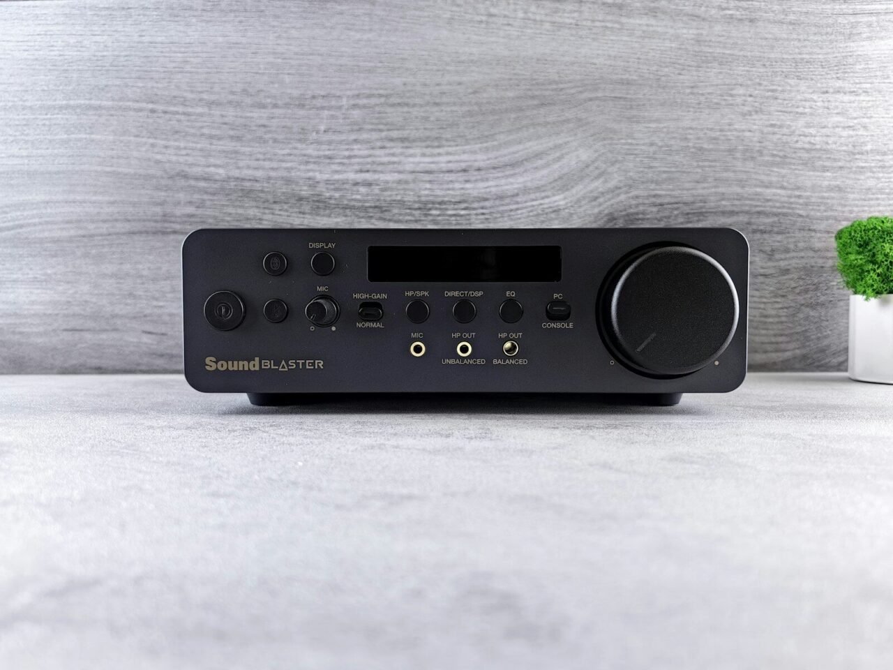 a radio sitting on top of a table next to a plant