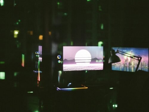 black flat screen tv turned on in a dark room