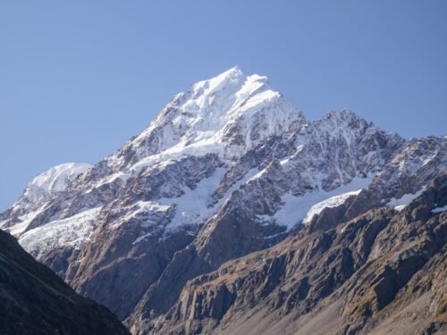 a mountain range with a lake in the foreground