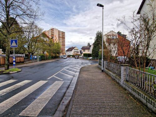 an empty street with a street light on the side of it