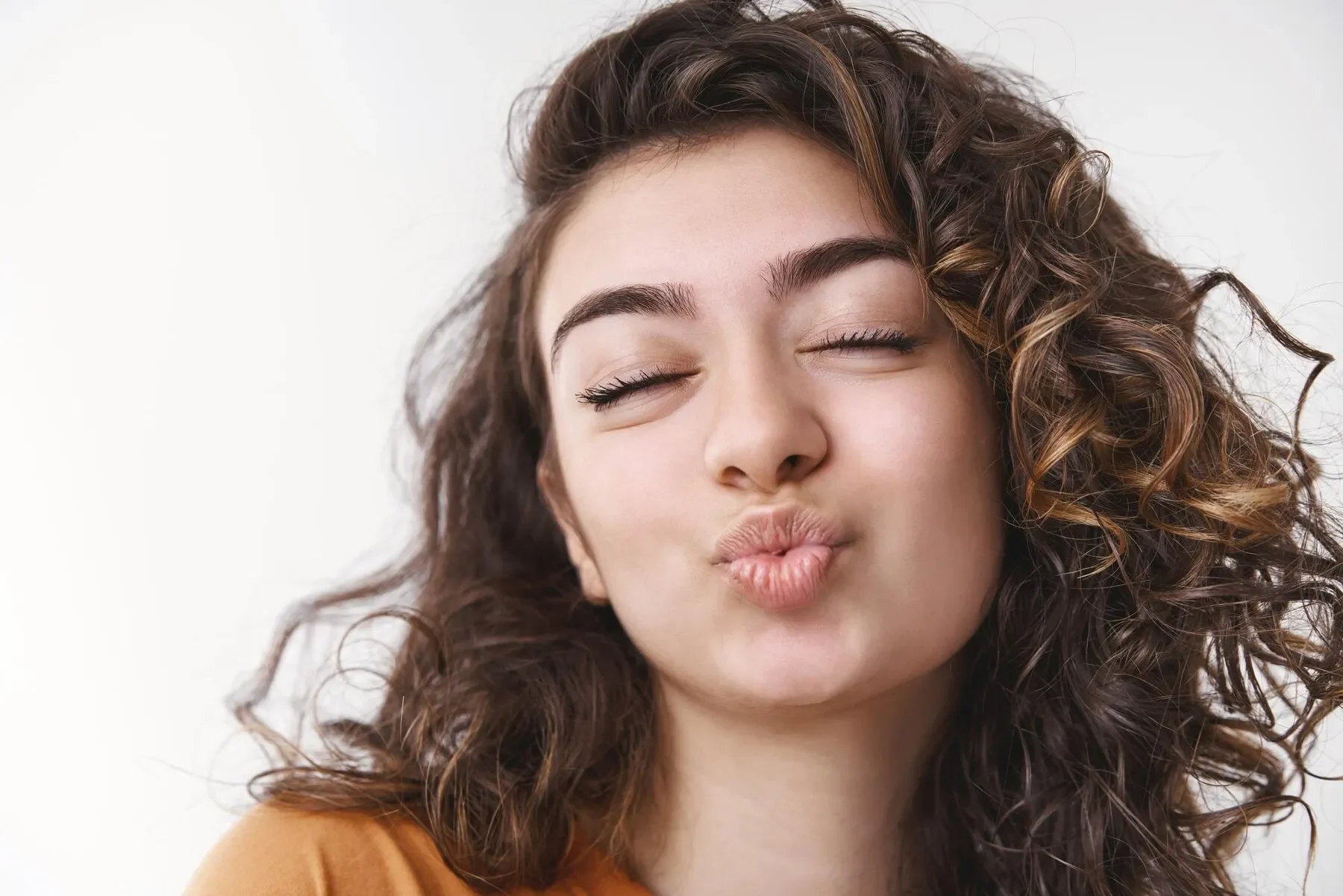 Girl black curly hair folding lips close eyes waiting