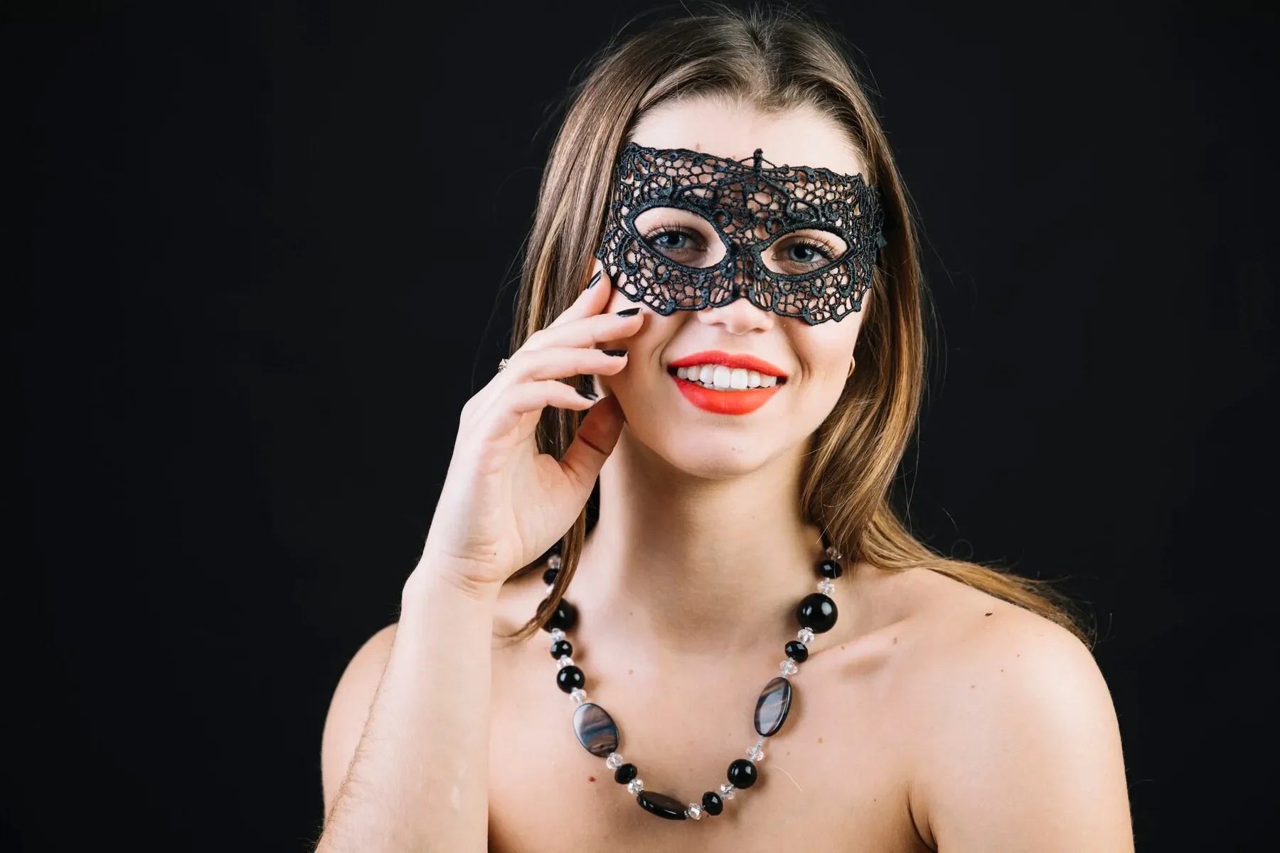 Happy topless woman wearing masquerade carnival mask