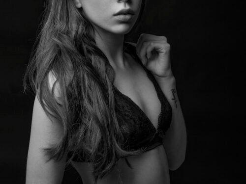 grayscale photography of woman wearing brassiere
