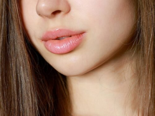 a close up of a woman with long brown hair