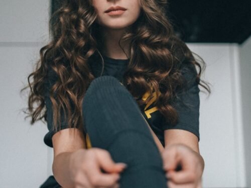 a woman sitting on the floor with her legs crossed
