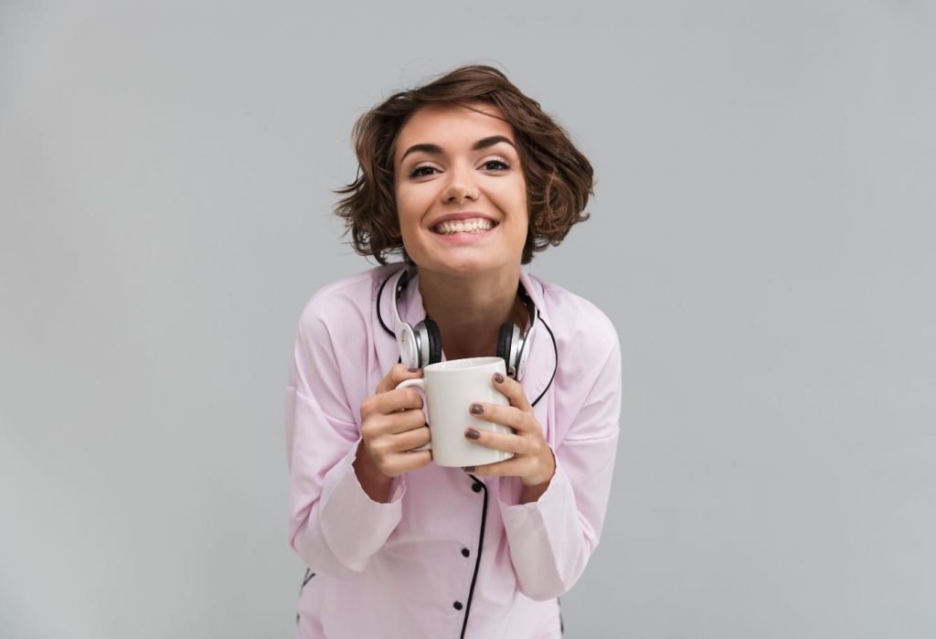 smiling woman holding cup