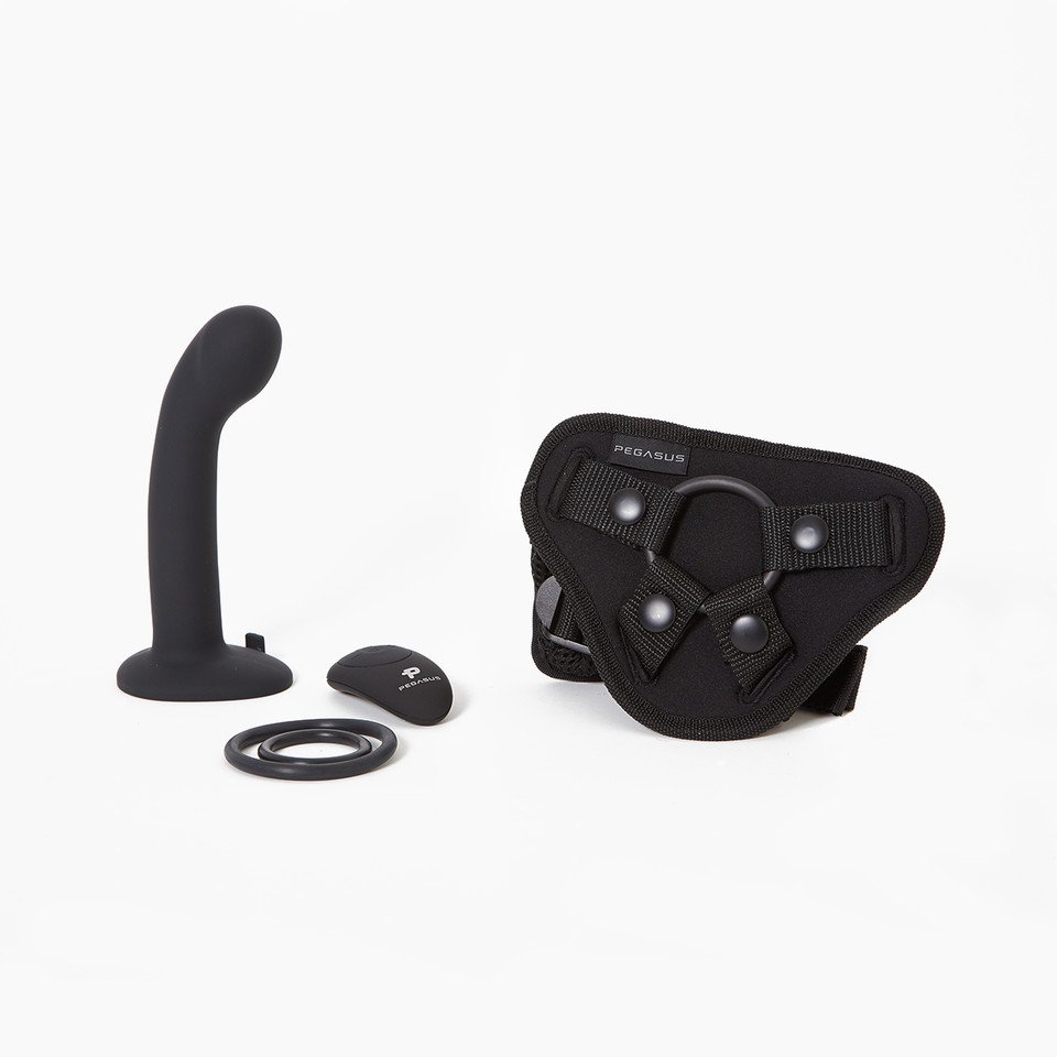 A black P & G-spot dildo with a flared base next to a harness and remote control A black P & G-spot dildo with a flared base next to a harness and remote control