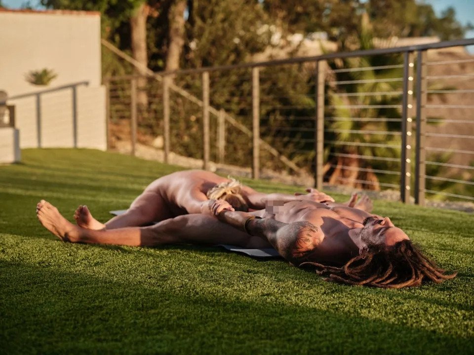 The seated wide-legged forward fold illustrated here requires teamwork. True Naked Yoga
