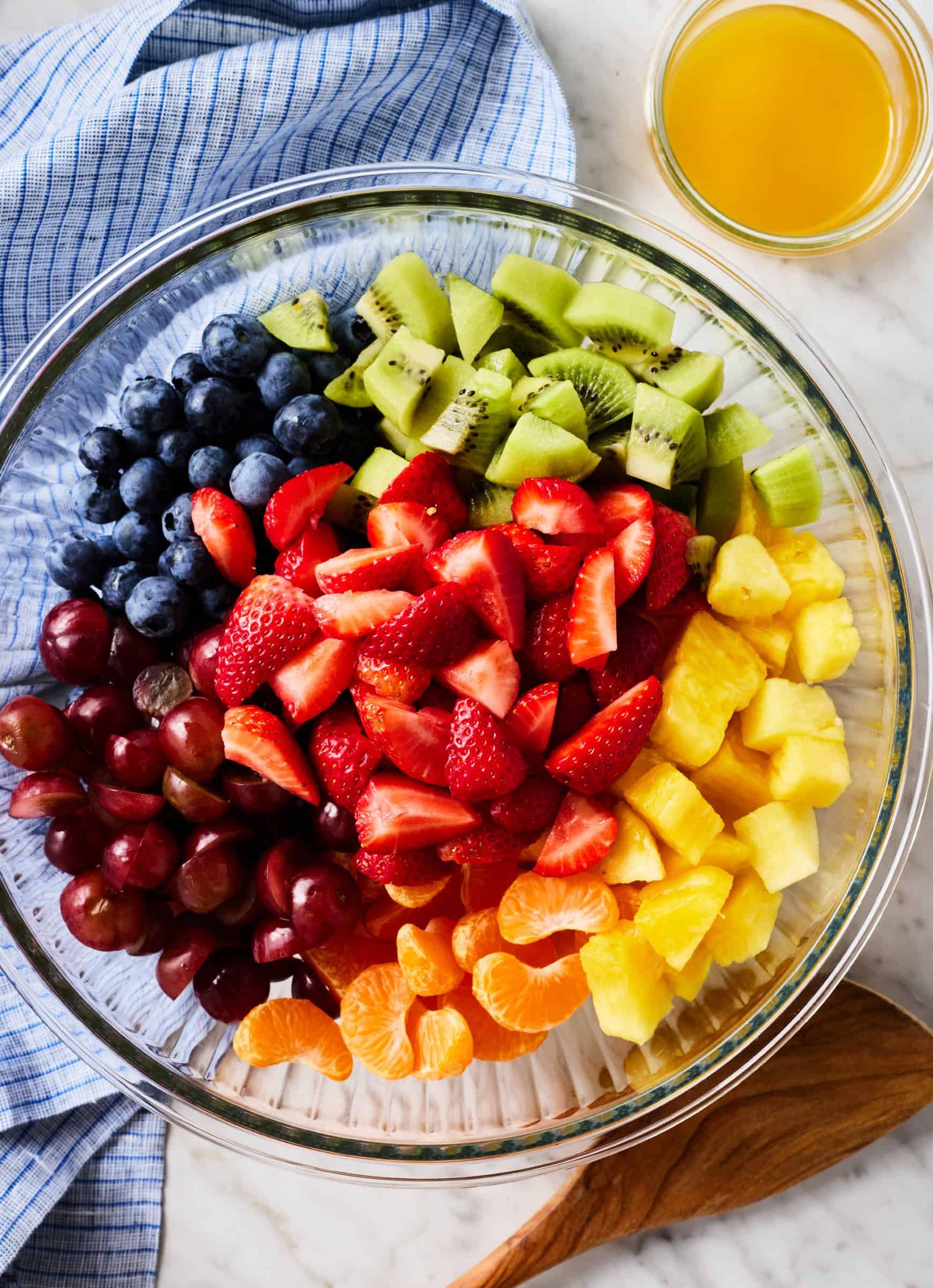 Fruit salad ingredients in glass bowl