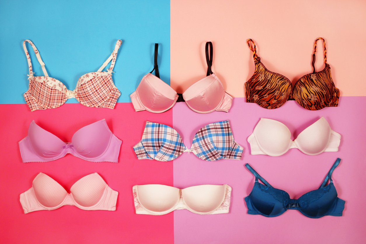 An image of a set of different bras on a multicolored background.
