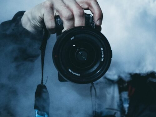 person holding DSLR camera