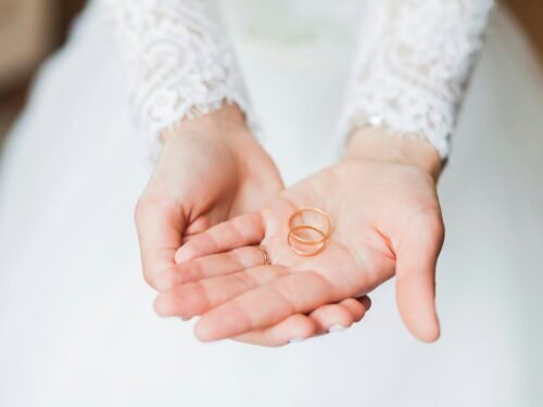 person holding copper rings during daytime
