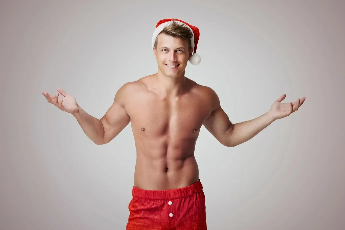 Male sexy santa grey wall