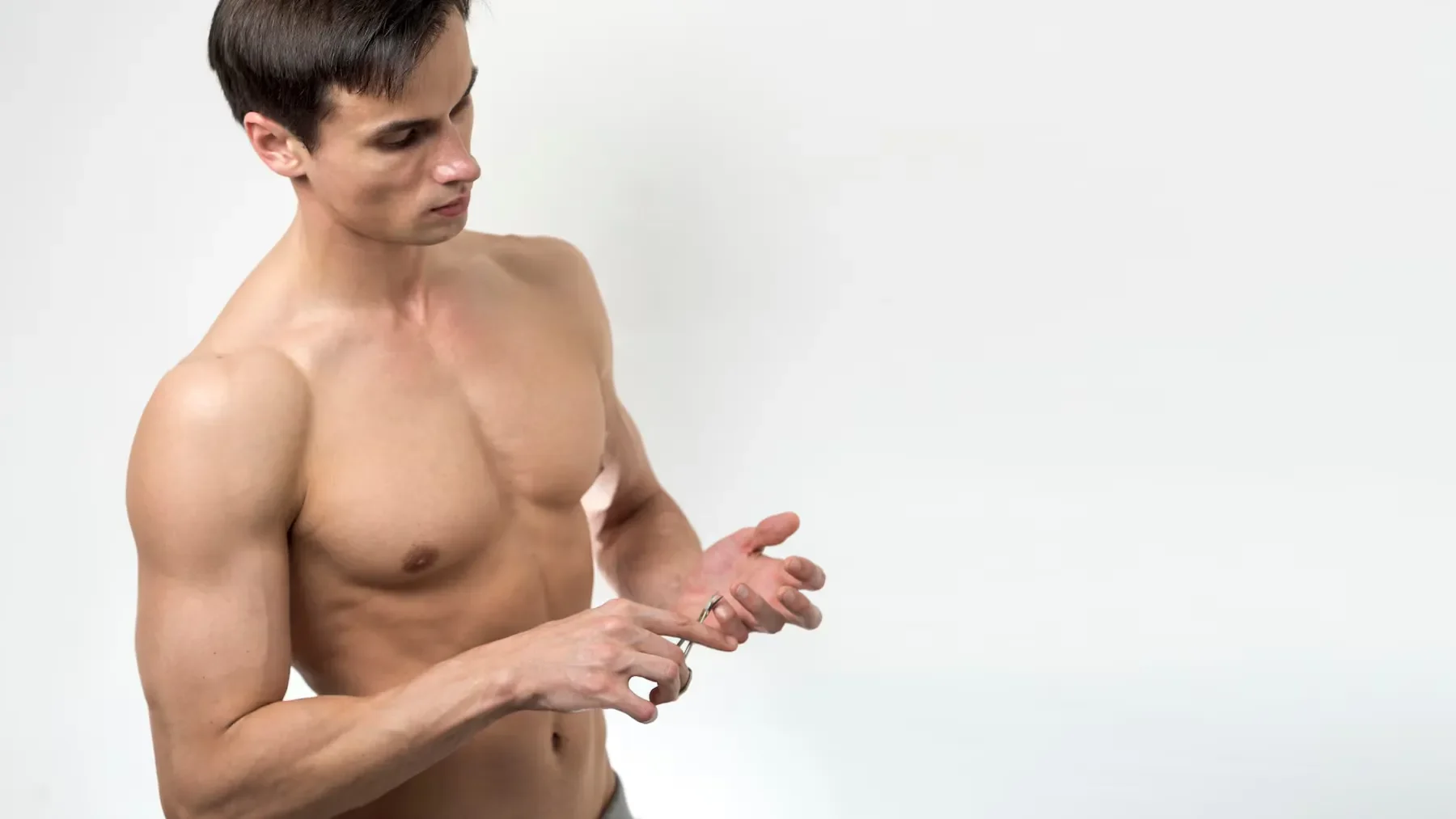 Man cutting his fingernails with copy space