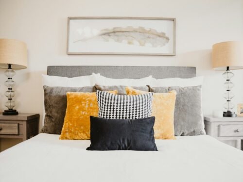 black and white throw pillows on white bed