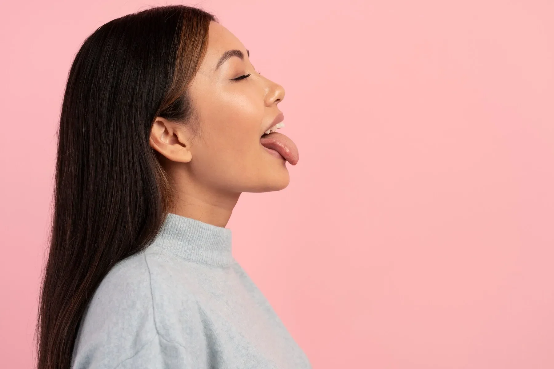 Medium shot woman sticking out tongue