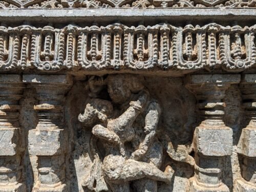 a carving of a man and a woman on a wall