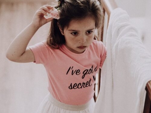 girl in pink and white crew neck t-shirt and white skirt