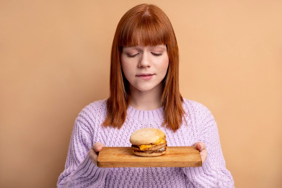 Person with eating disorder trying eat fast food